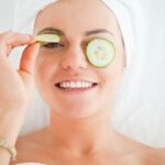 young-woman-cucumber-slices-face-20099172